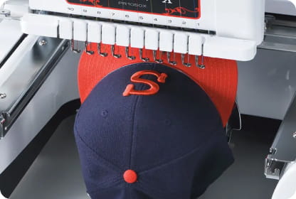 Blue and red cap in embroidery machine